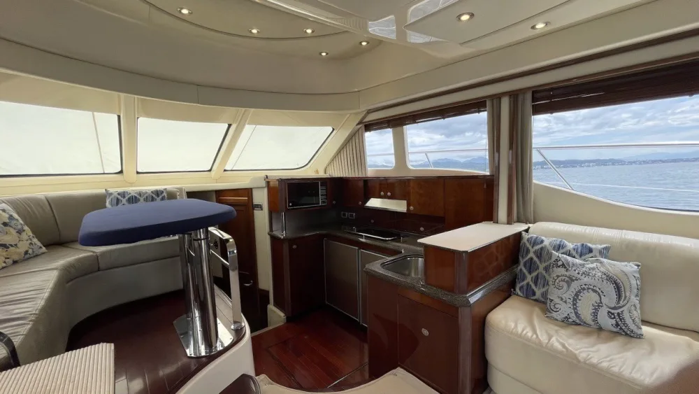 Shaded interior salon of a Sea Ray 52 yacht rental in Puerto Vallarta, a good spot to protect a fresh tattoo from the sun